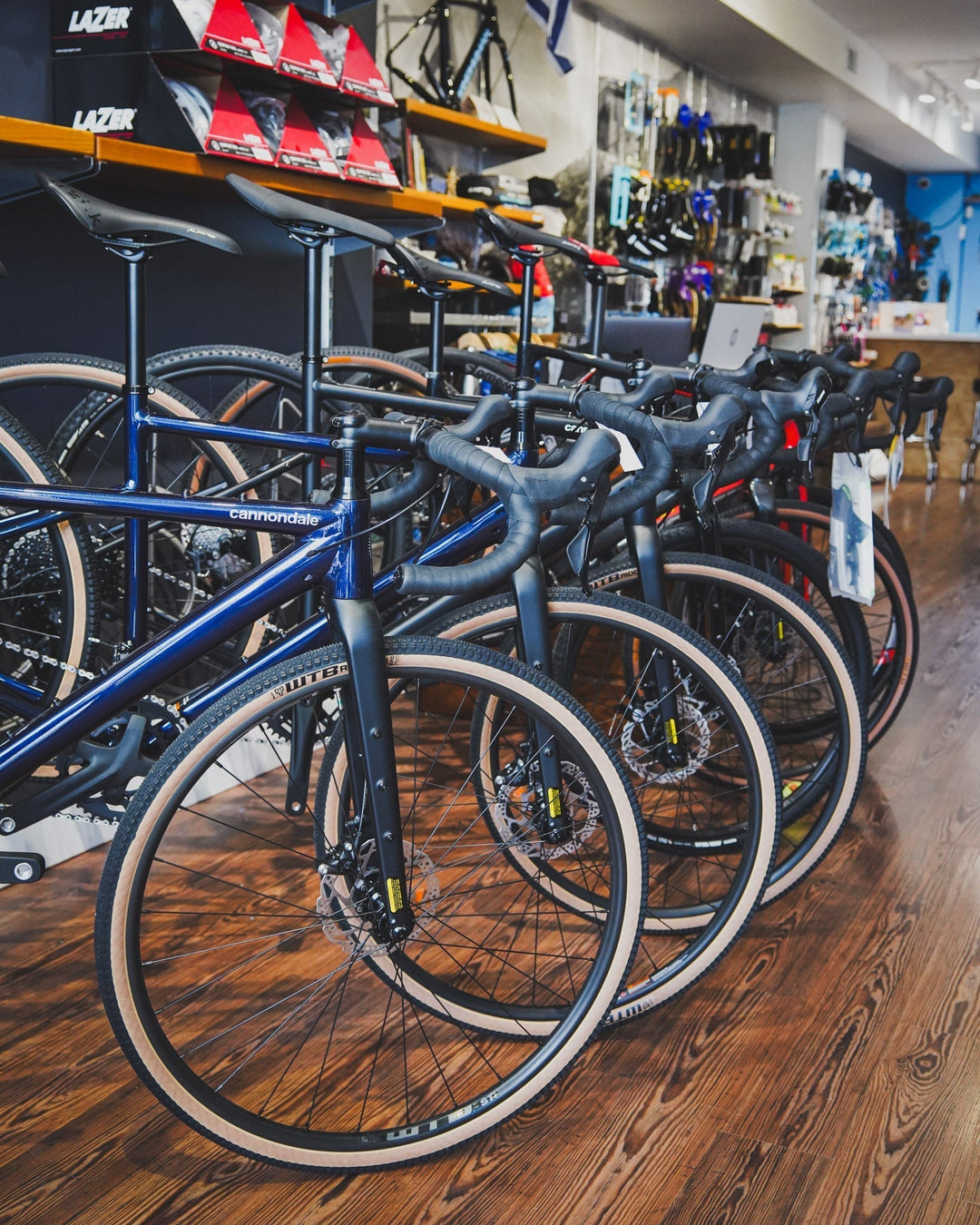 A photo of road bikes lined up inside a bike shop.